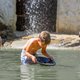Junge sucht nach Gold in einem Teich
