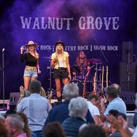 Walnut Grove Vier Personen auf einer Bühne vor Publikum